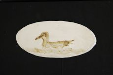 White oval plate with duck paint.